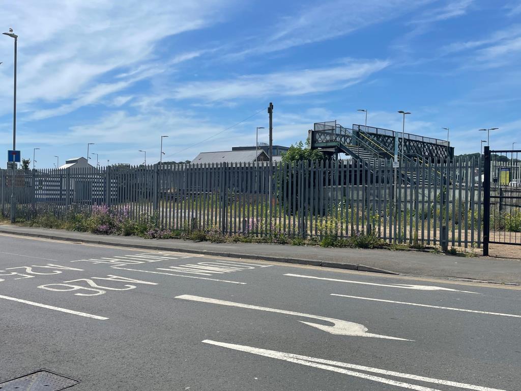 Lot: 99 - LAND WITH RESIDENTIAL PLANNING FOR 33 UNITS - Front of site with fencing and hardstanding